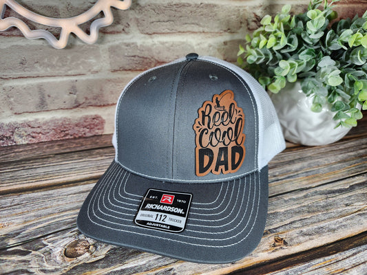 Reel Cool Dad" Trucker Hat - Fishing Dad Graphic Cap, Adjustable Snapback, Multiple Colors & Patch Designs